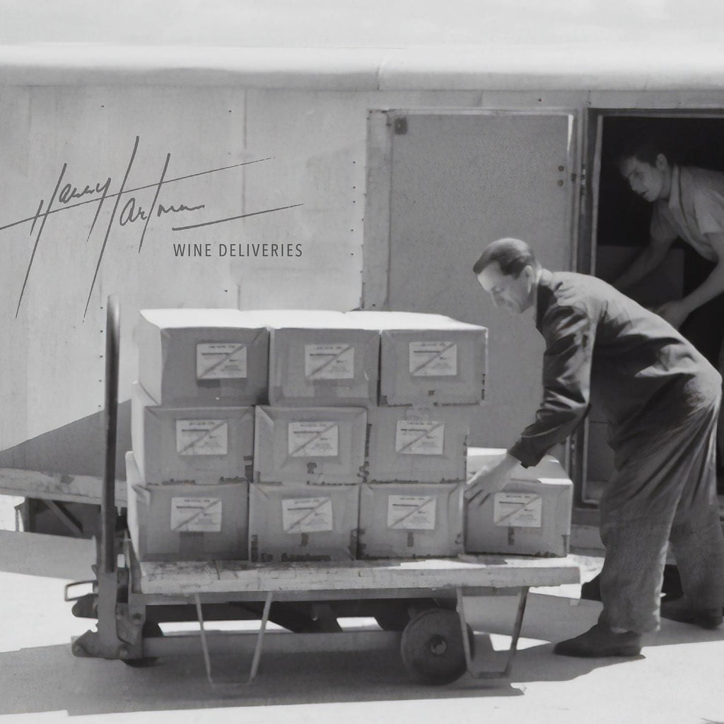 Man pushing a trolley with Harry Hartman labelled boxes of wine