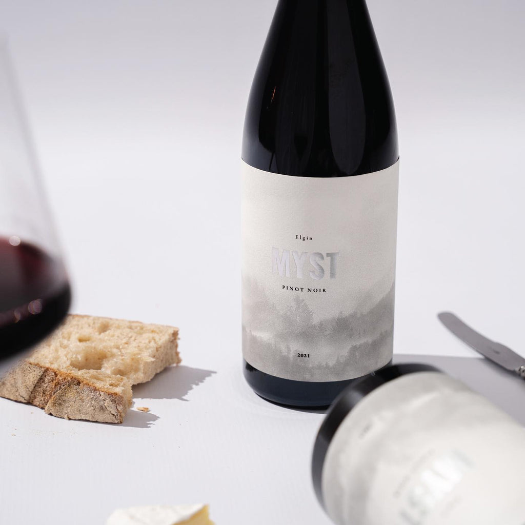 Harry Hartman Myst 2022 Pinot Noir bottle with bread and red wine