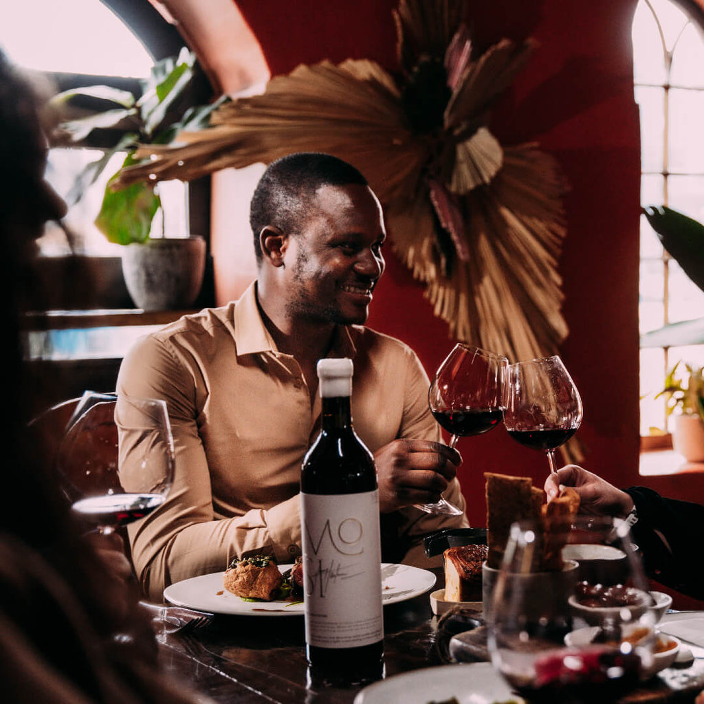 Joseph Dhafana cheers Mosi Bordeaux blend wine with friend 