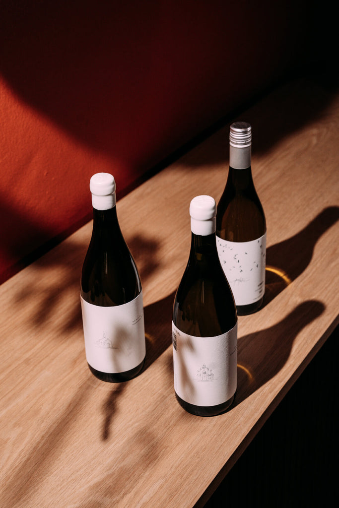 3 bottles of Harry Hartman wine on a table