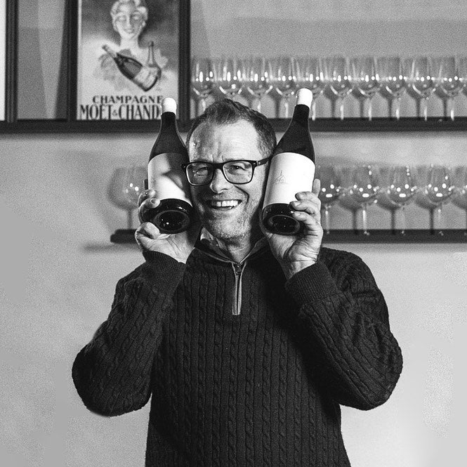 Graphic designer and founder of Harry Hartman Sean Harrison with 2 bottles of somesay